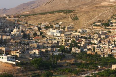 Feeki in 2010. The white dome on the left is the same basilica the village built in 1937, finished now; the cemetery lies below it and the bare mountain still stands behind.